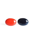 Solo resin stud earrings from the Chroma collection in red and ink blue on a white background