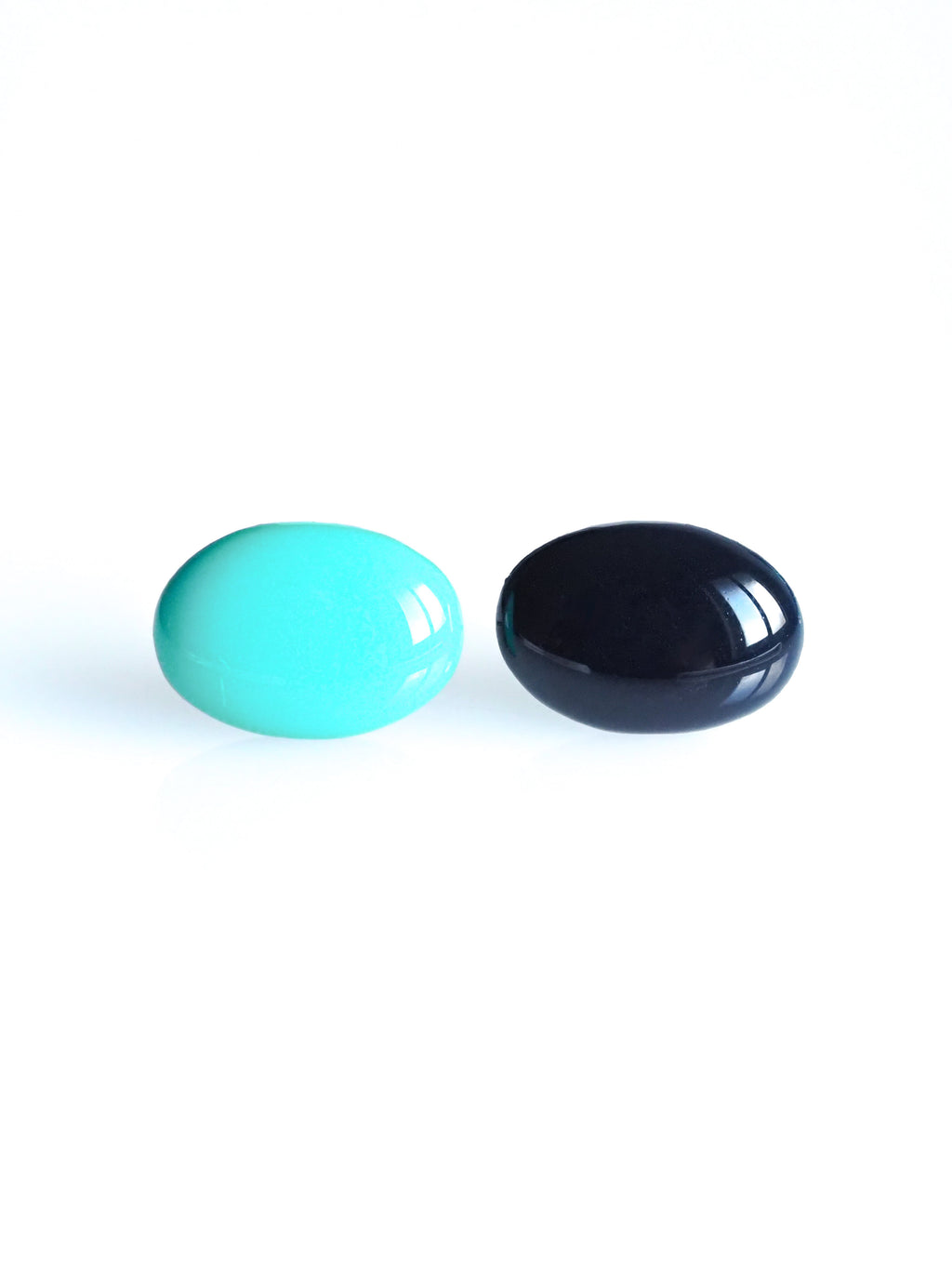 Solo resin stud earrings from the Chroma collection in turquoise and ink blue on a white background