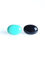 Solo resin stud earrings from the Chroma collection in turquoise and ink blue on a white background