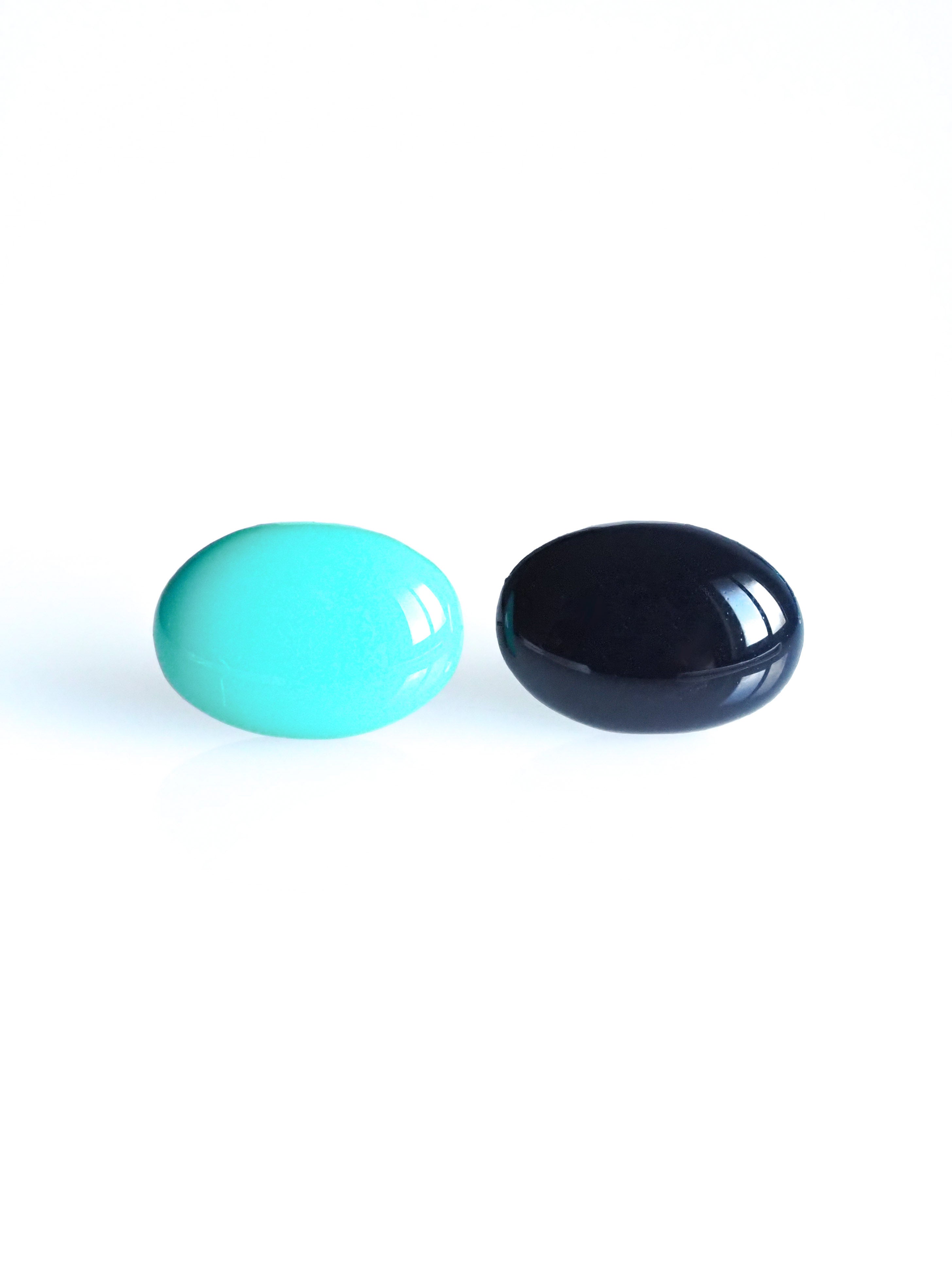 Solo resin stud earrings from the Chroma collection in turquoise and ink blue on a white background