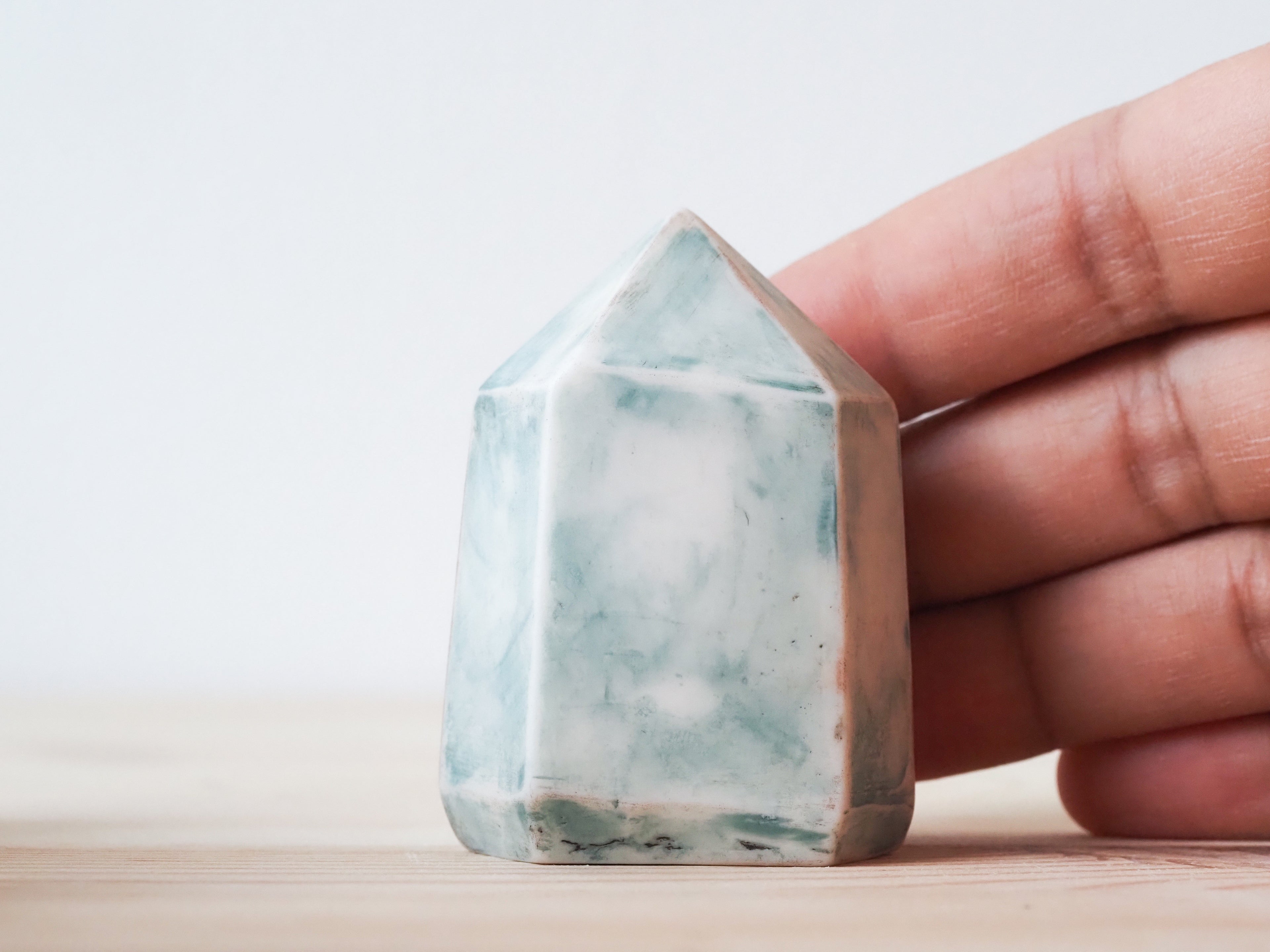 Handcrafted porcelain crystal sculpture, unique sculptural decorative piece with textured surface, subtle tints, and natural variations.