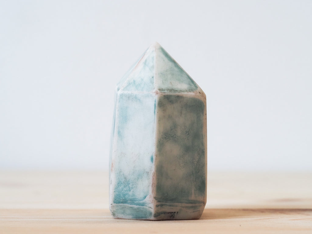 Handcrafted porcelain crystal sculpture, unique sculptural decorative piece with textured surface, subtle tints, and natural variations.