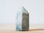 Handcrafted porcelain crystal sculpture, unique sculptural decorative piece with textured surface, subtle tints, and natural variations.