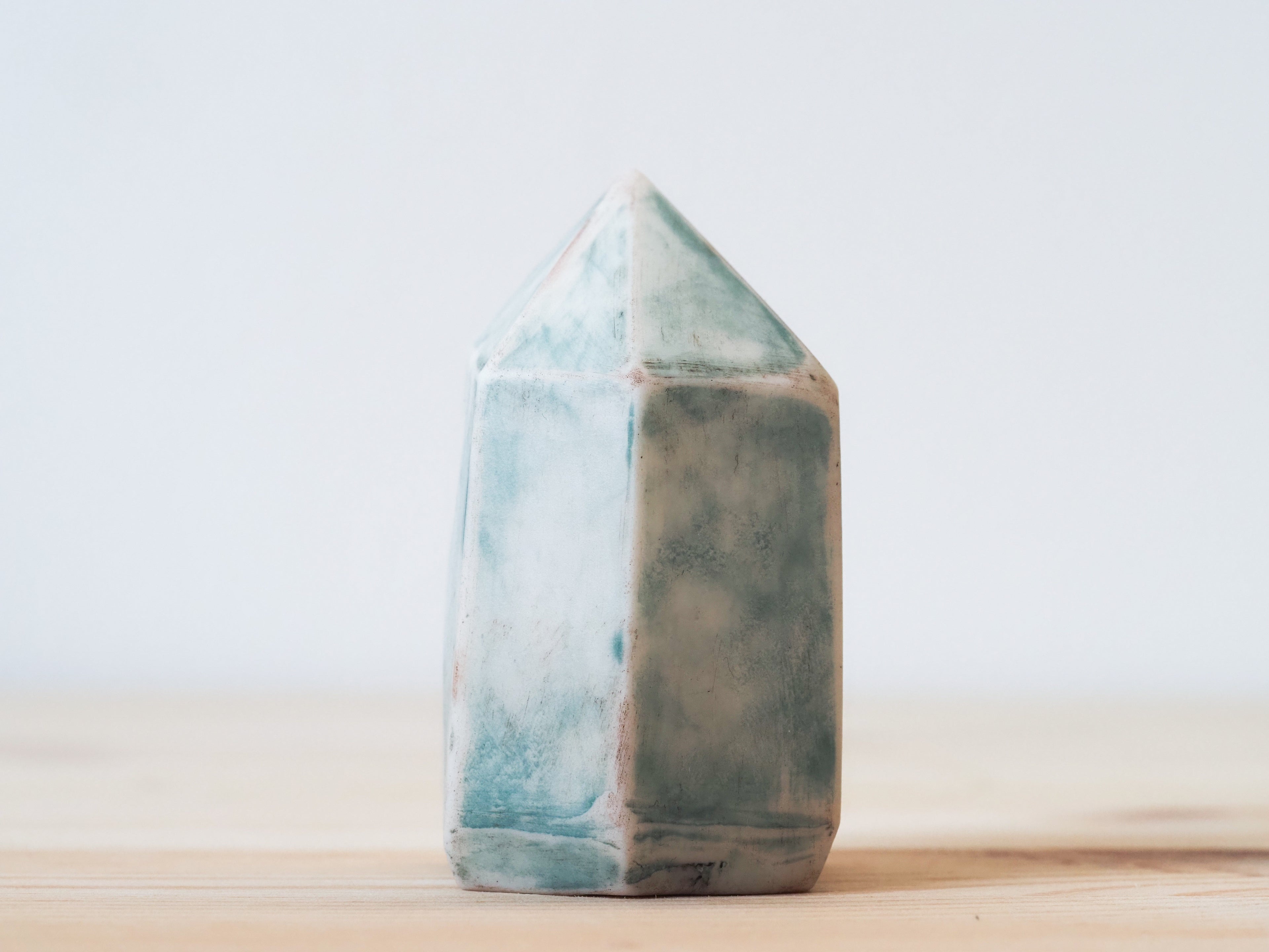 Handcrafted porcelain crystal sculpture, unique sculptural decorative piece with textured surface, subtle tints, and natural variations.
