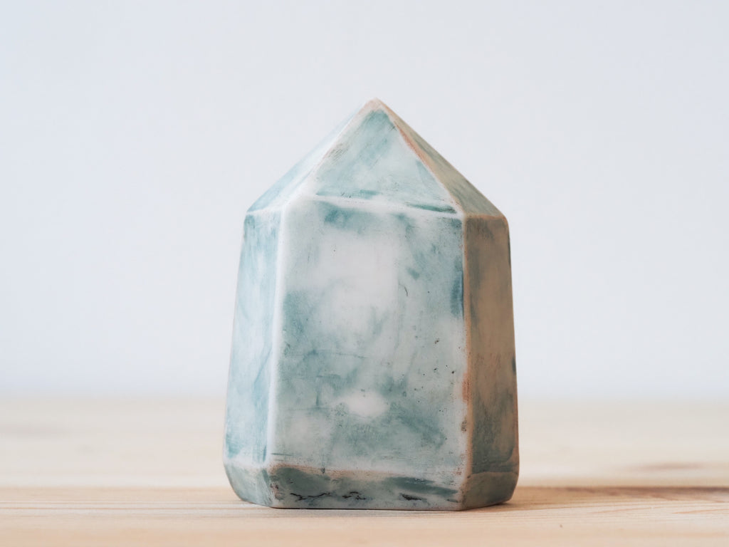 Handcrafted porcelain crystal sculpture, unique sculptural decorative piece with textured surface, subtle tints, and natural variations.