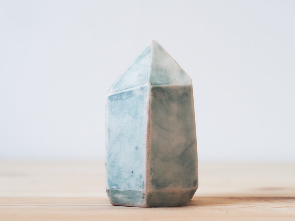 Handcrafted porcelain crystal sculpture, unique sculptural decorative piece with textured surface, subtle tints, and natural variations.