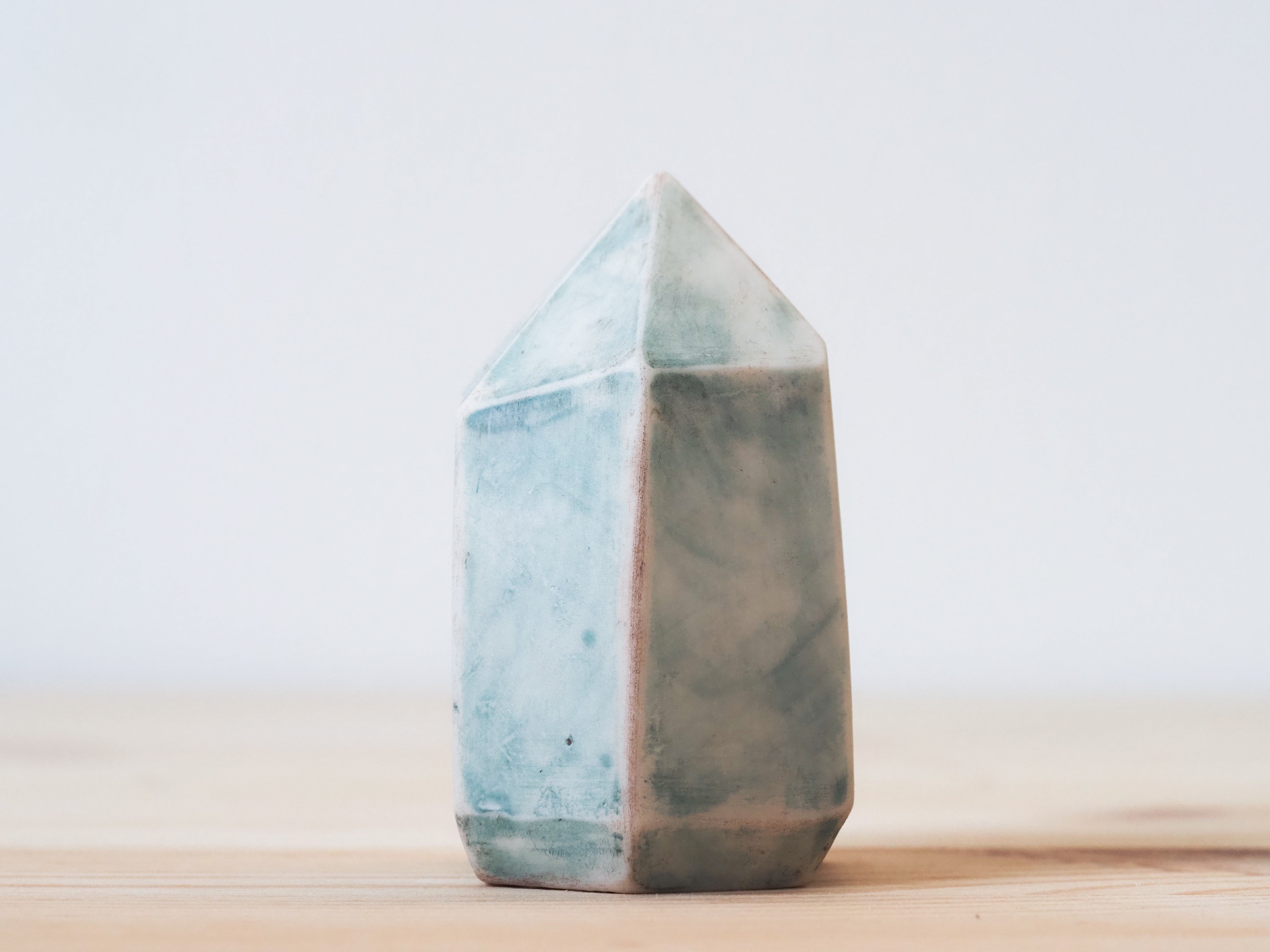 Handcrafted porcelain crystal sculpture, unique sculptural decorative piece with textured surface, subtle tints, and natural variations.