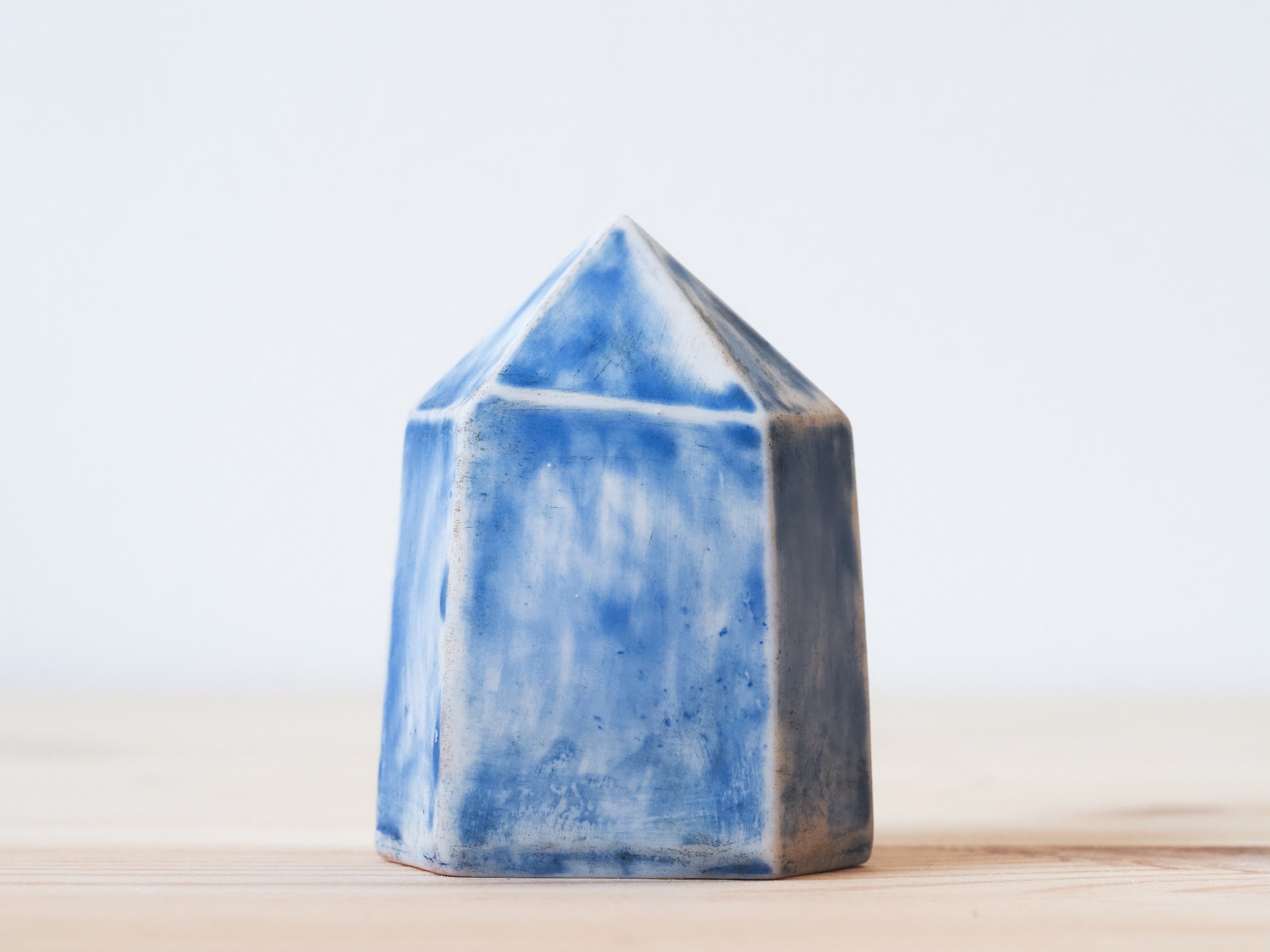 Handcrafted porcelain crystal sculpture, unique sculptural decorative piece with textured surface, subtle tints, and natural variations.