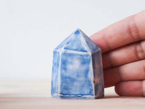 Handcrafted porcelain crystal sculpture, unique sculptural decorative piece with textured surface, subtle tints, and natural variations.