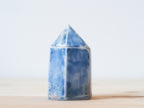 Handcrafted porcelain crystal sculpture, unique sculptural decorative piece with textured surface, subtle tints, and natural variations.