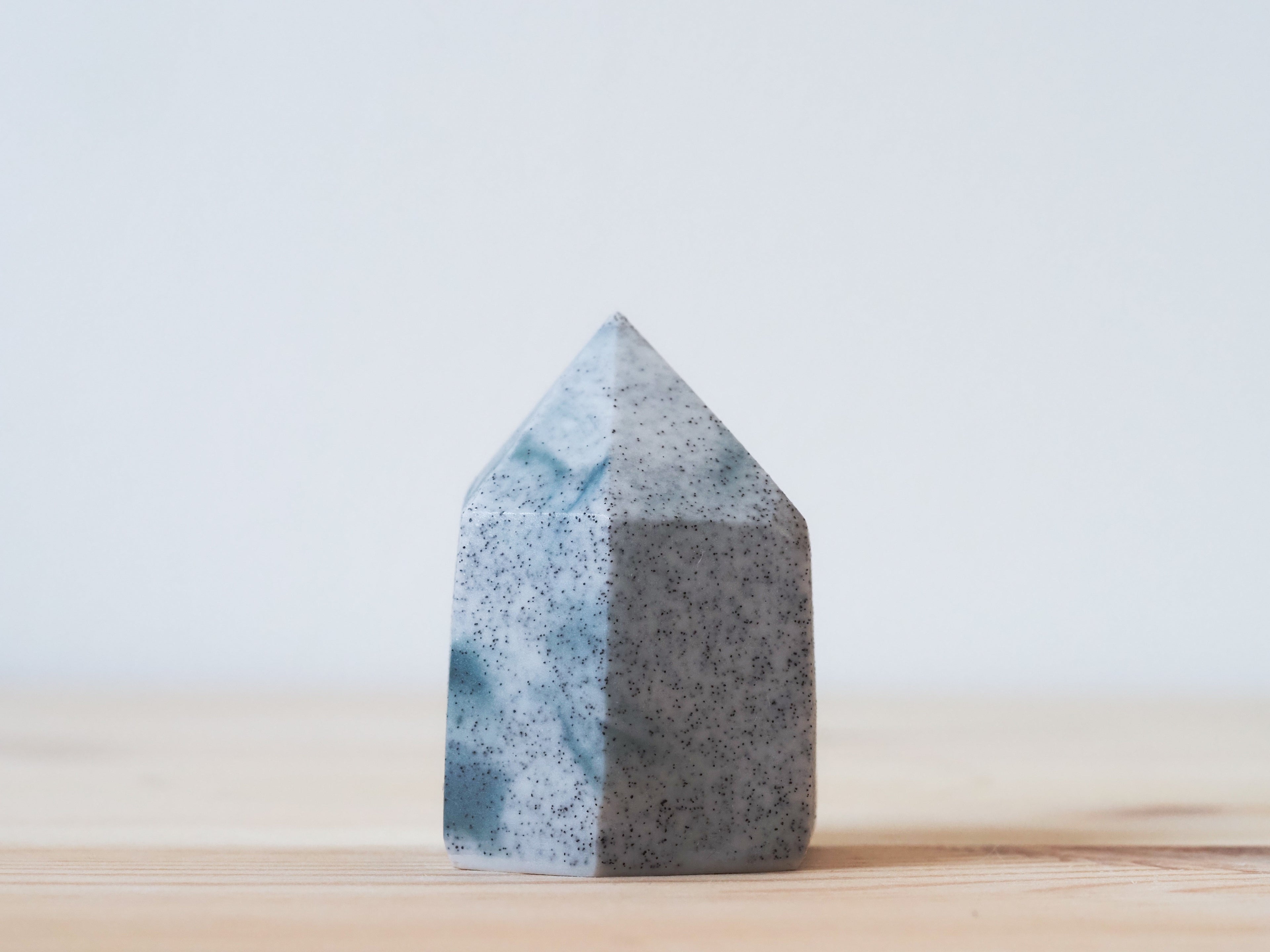 Handcrafted porcelain crystal sculpture, unique sculptural decorative piece with textured surface, subtle tints, and natural variations.