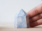 Handcrafted porcelain crystal sculpture, unique sculptural decorative piece with textured surface, subtle tints, and natural variations.