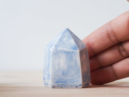 Handcrafted porcelain crystal sculpture, unique sculptural decorative piece with textured surface, subtle tints, and natural variations.