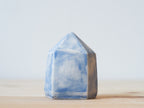 Handcrafted porcelain crystal sculpture, unique sculptural decorative piece with textured surface, subtle tints, and natural variations.