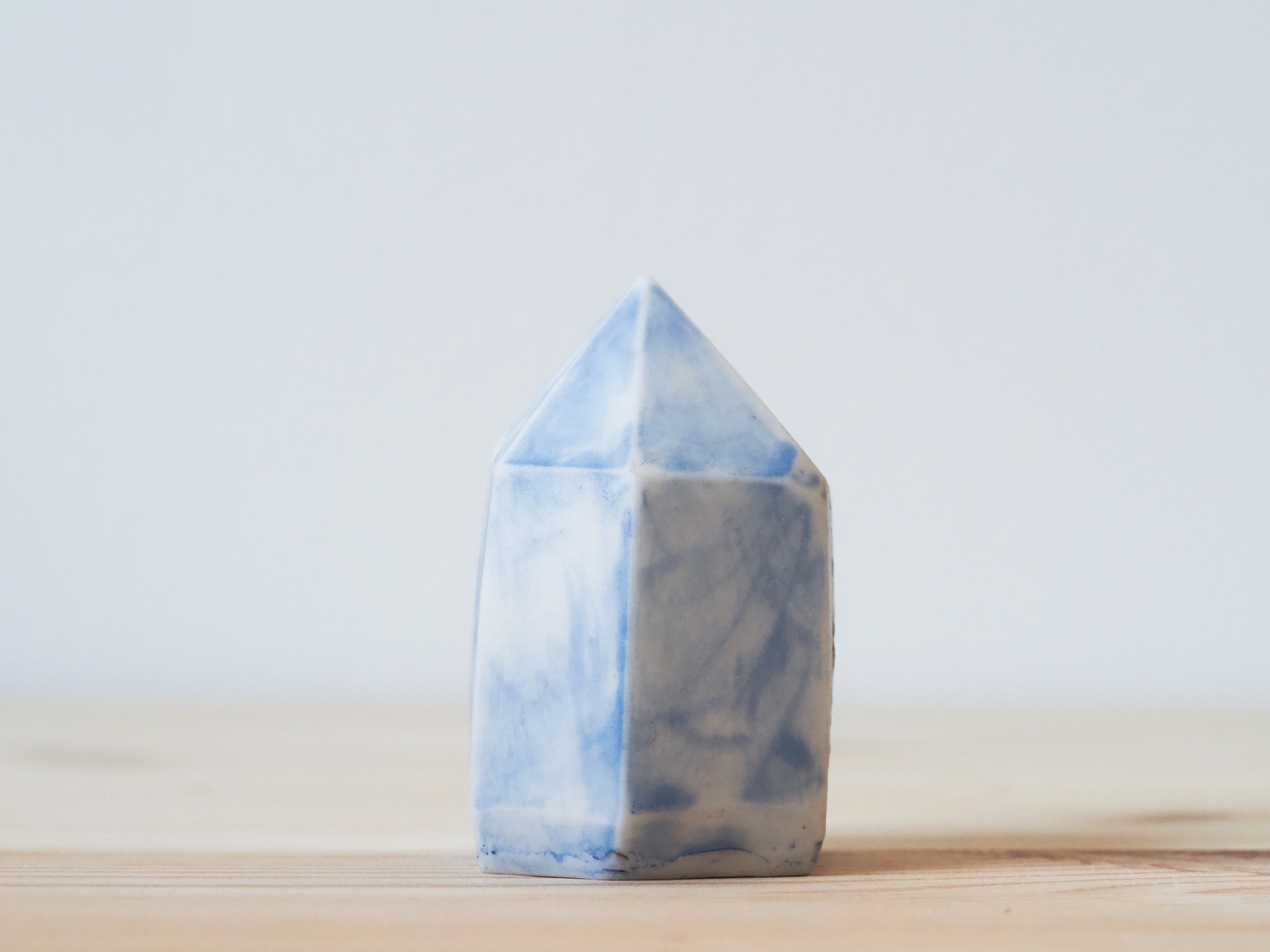 Handcrafted porcelain crystal sculpture, unique sculptural decorative piece with textured surface, subtle tints, and natural variations.