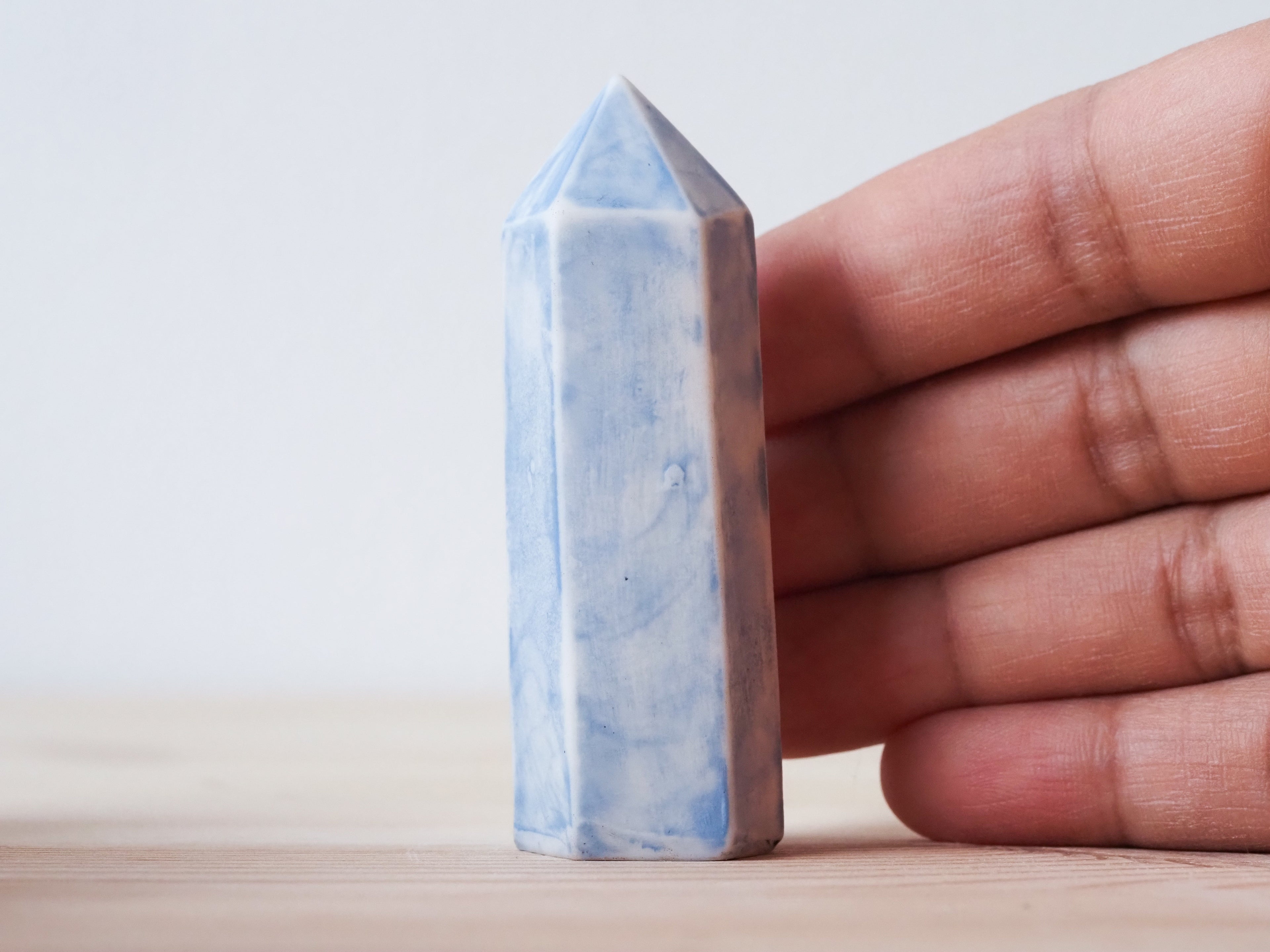Handcrafted porcelain crystal sculpture, unique sculptural decorative piece with textured surface, subtle tints, and natural variations.