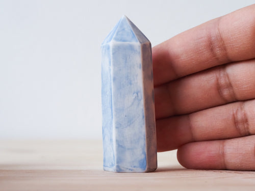 Handcrafted porcelain crystal sculpture, unique sculptural decorative piece with textured surface, subtle tints, and natural variations.