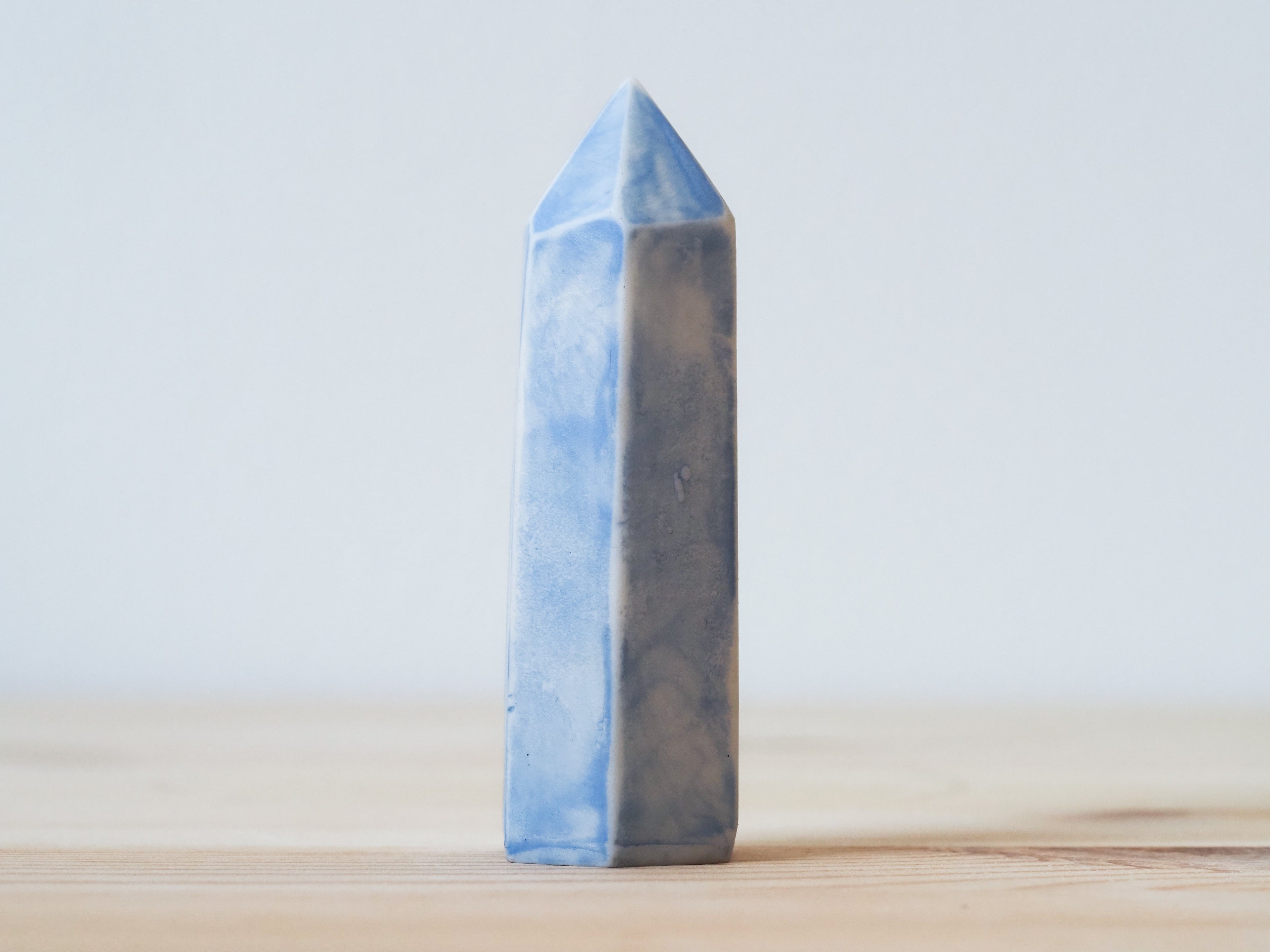 Handcrafted porcelain crystal sculpture, unique sculptural decorative piece with textured surface, subtle tints, and natural variations.