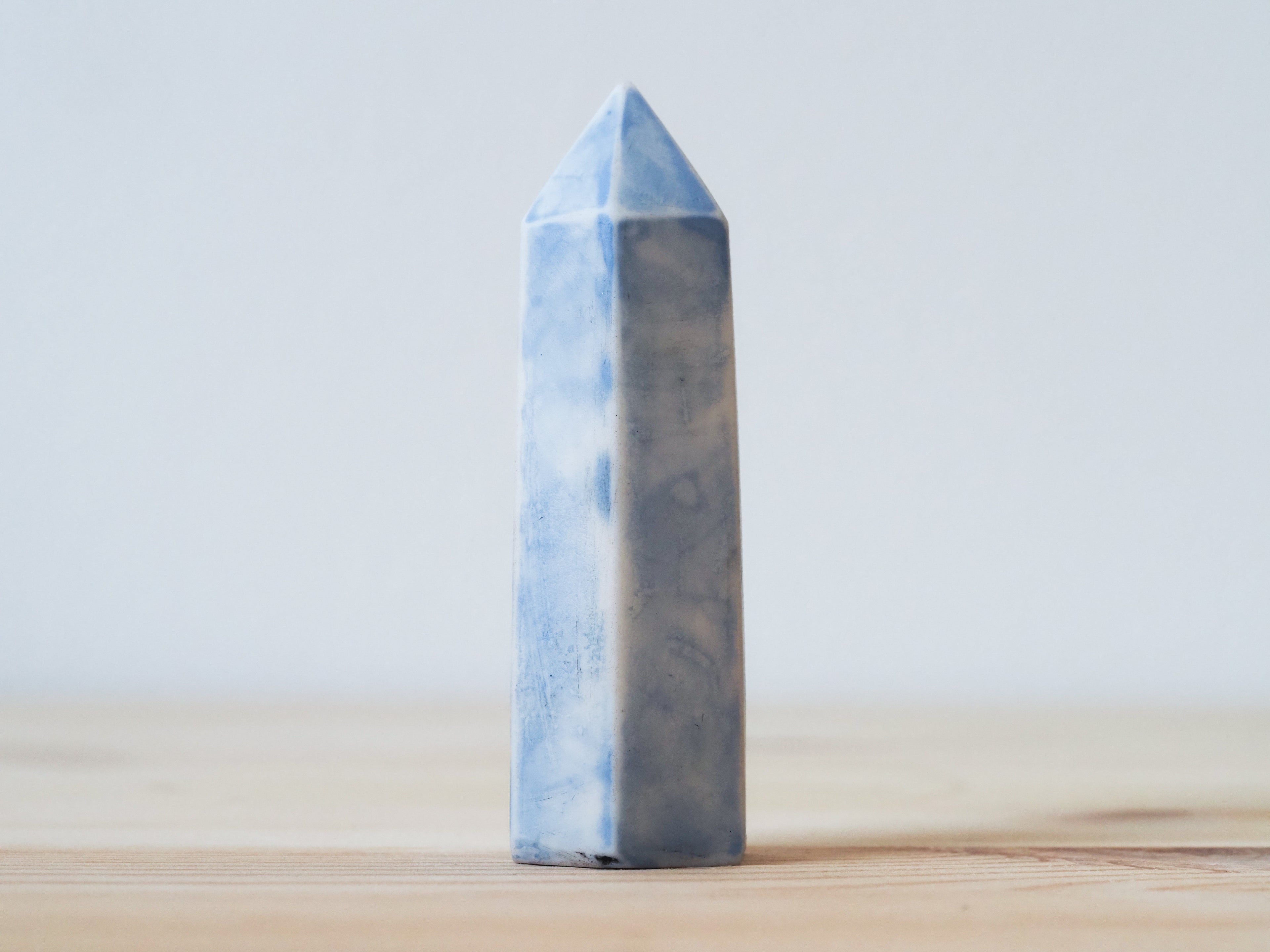 Handcrafted porcelain crystal sculpture, unique sculptural decorative piece with textured surface, subtle tints, and natural variations.