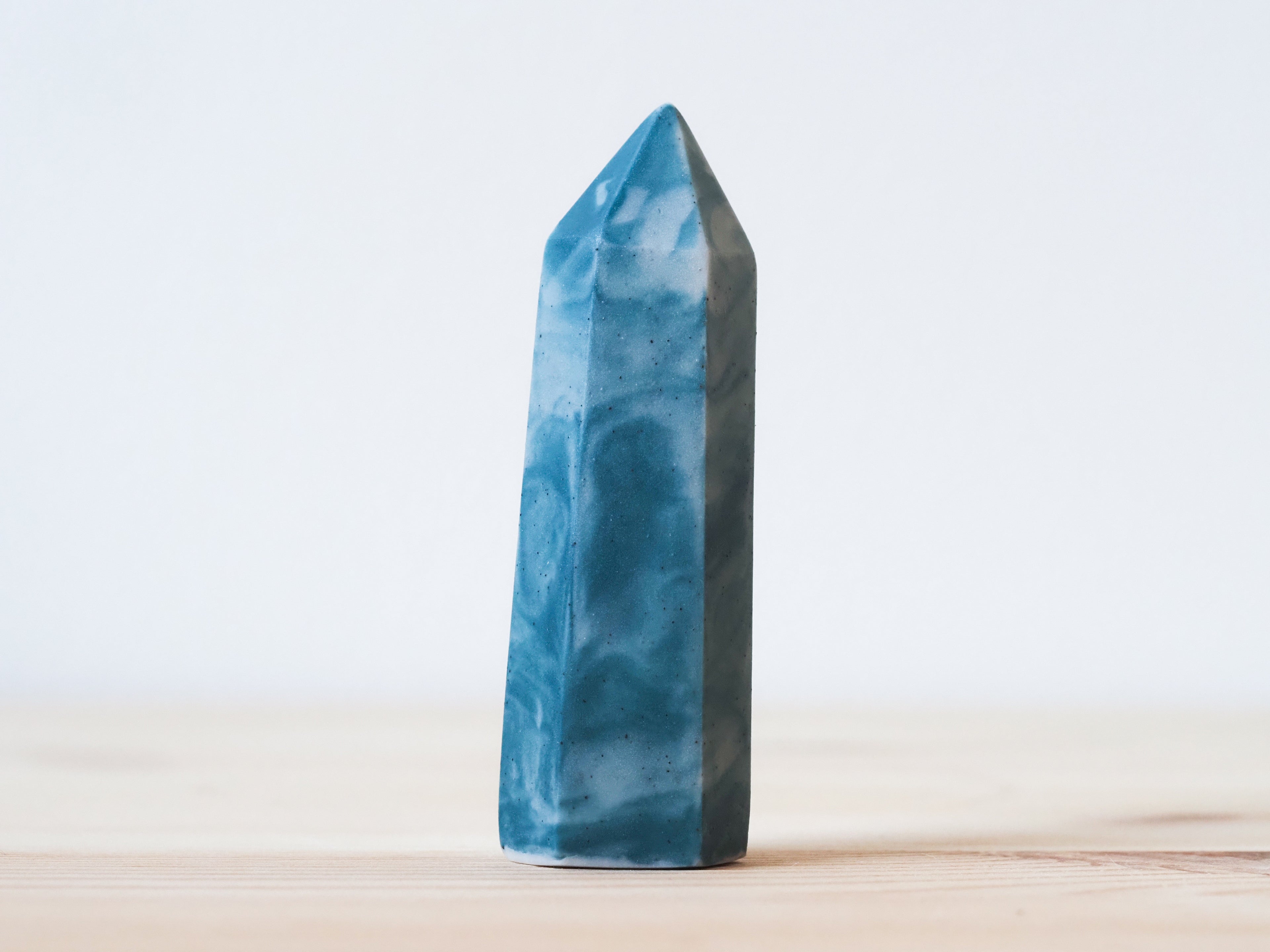Handcrafted porcelain crystal sculpture, unique sculptural decorative piece with textured surface, subtle tints, and natural variations.