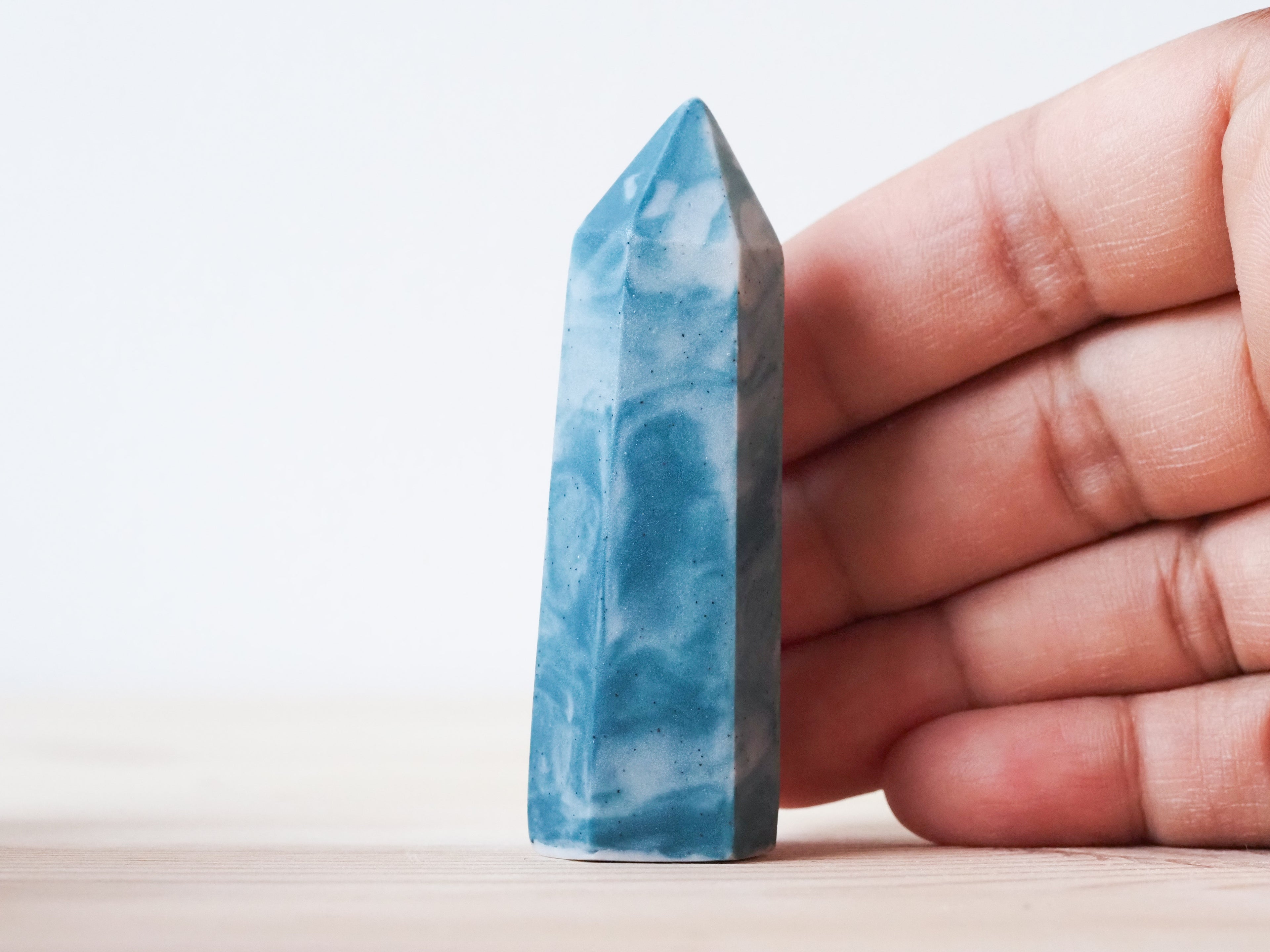 Handcrafted porcelain crystal sculpture, unique sculptural decorative piece with textured surface, subtle tints, and natural variations.