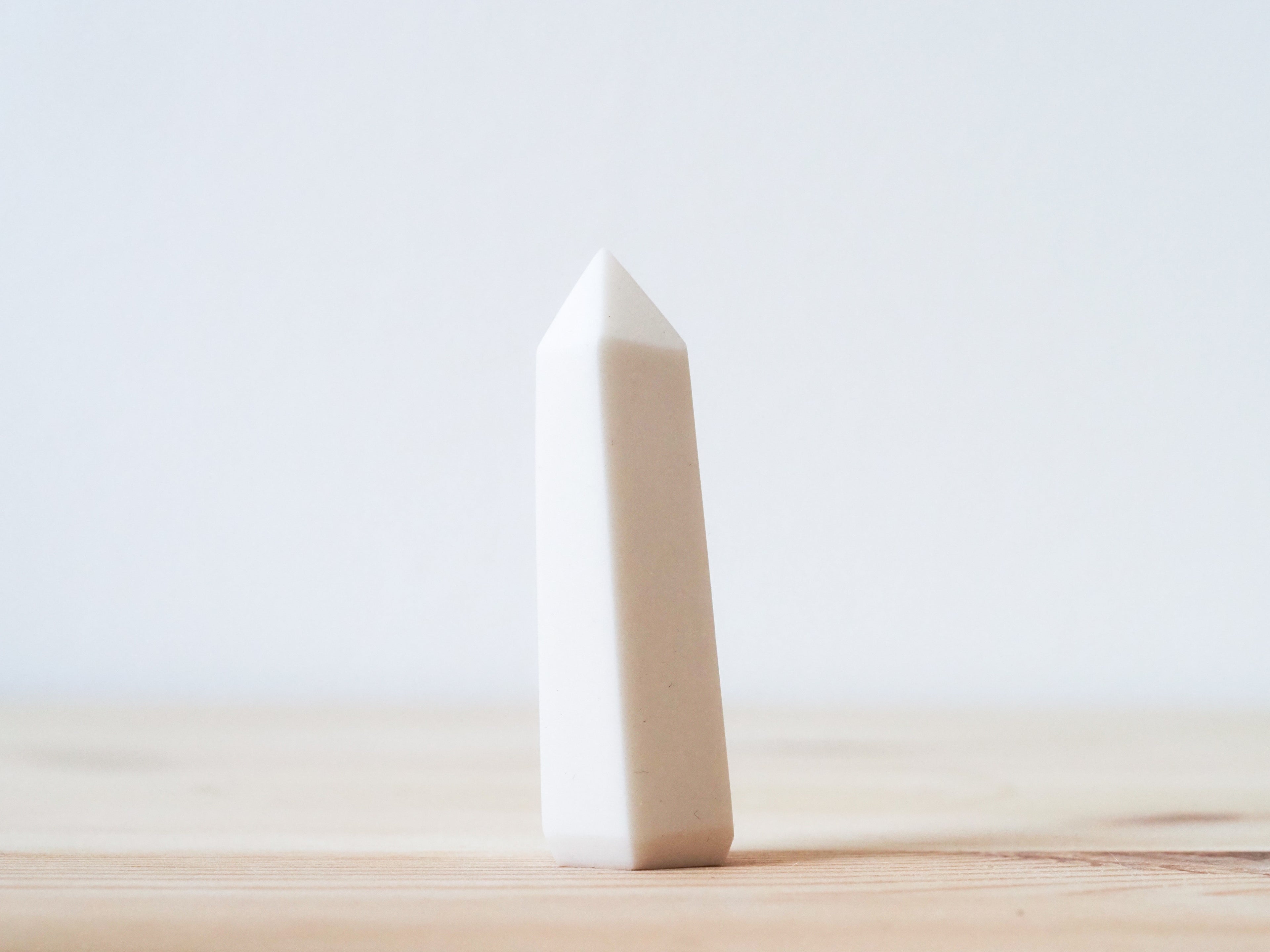Handcrafted porcelain crystal sculpture, unique sculptural decorative piece with textured surface, subtle tints, and natural variations.