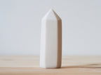 Handcrafted porcelain crystal sculpture, unique sculptural decorative piece with textured surface, subtle tints, and natural variations.