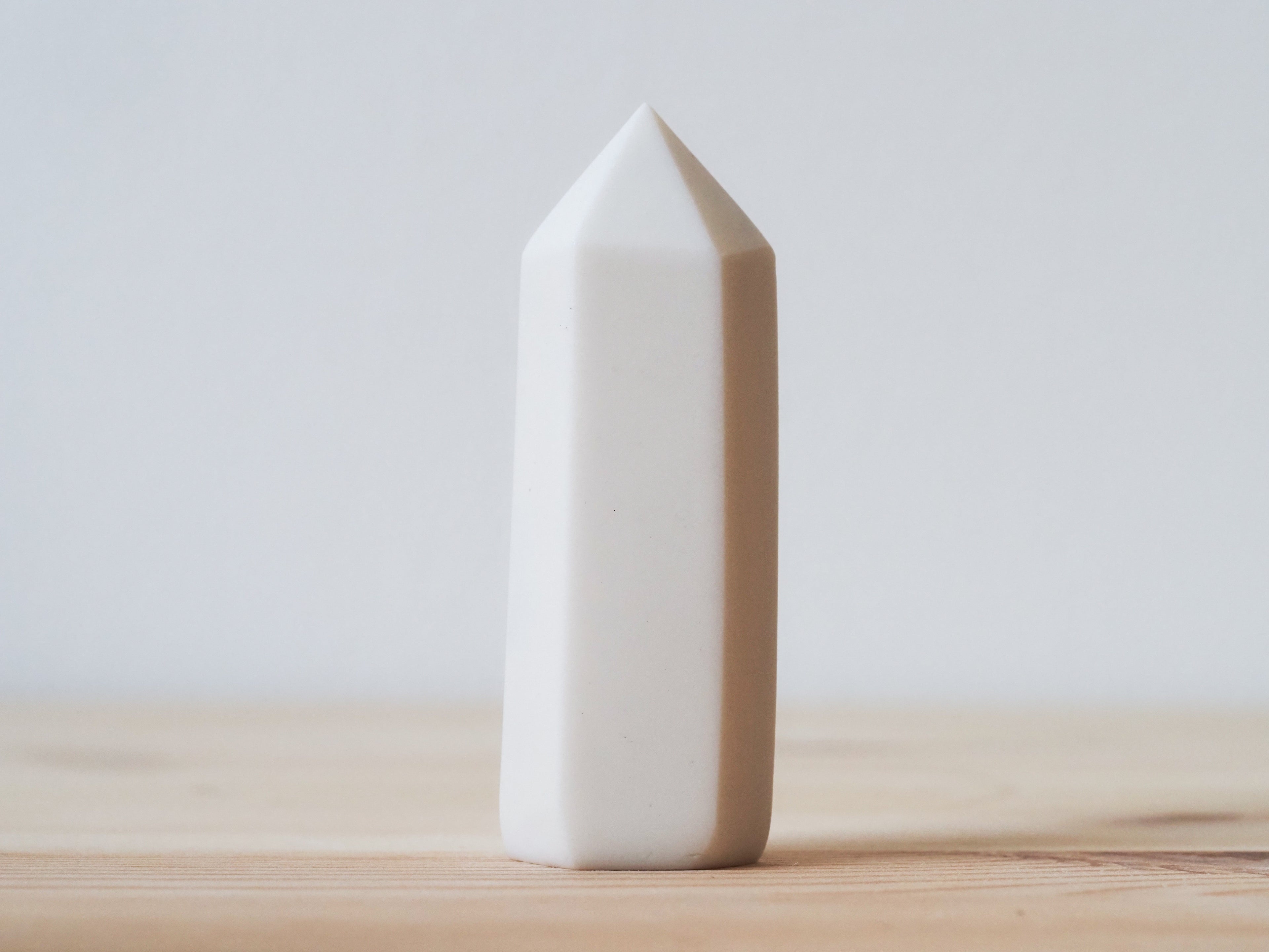 Handcrafted porcelain crystal sculpture, unique sculptural decorative piece with textured surface, subtle tints, and natural variations.