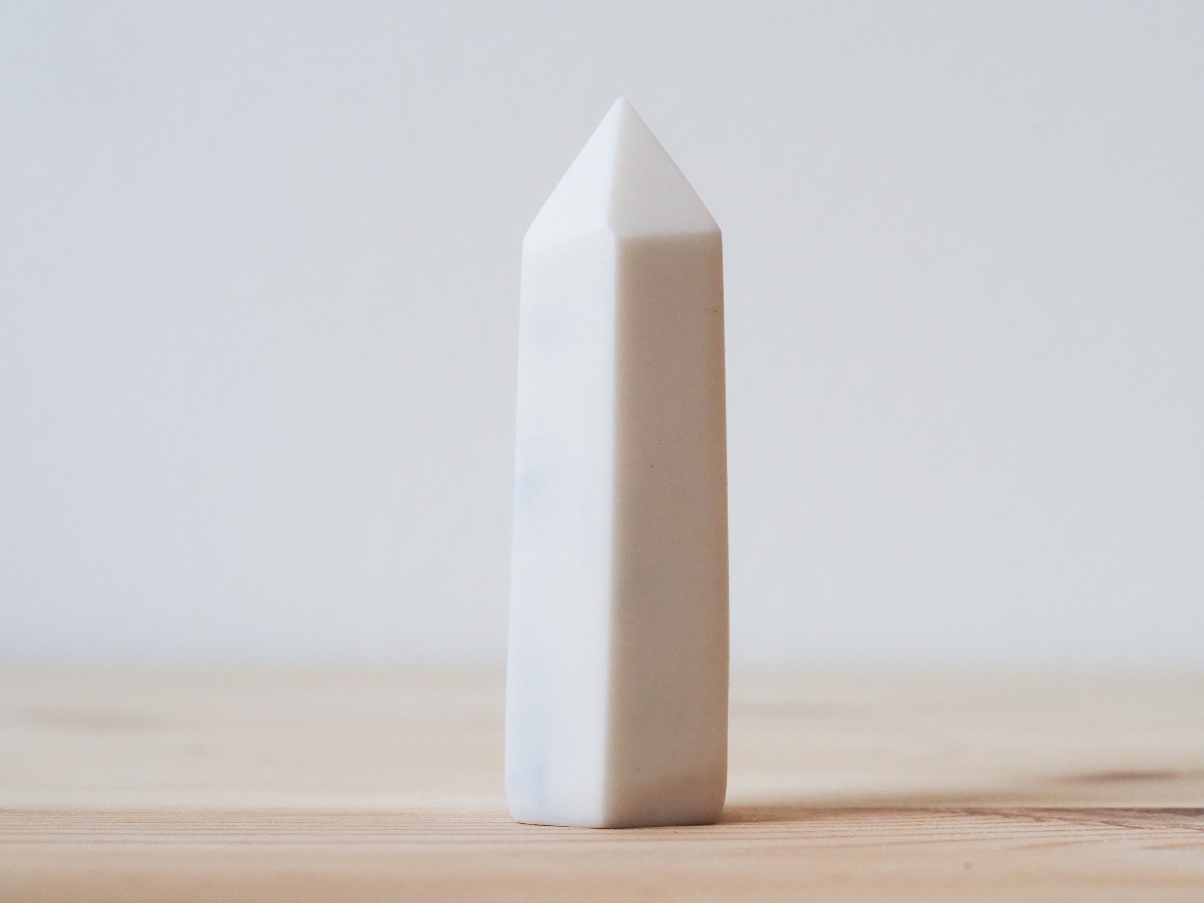 Handcrafted porcelain crystal sculpture, unique sculptural decorative piece with textured surface, subtle tints, and natural variations.
