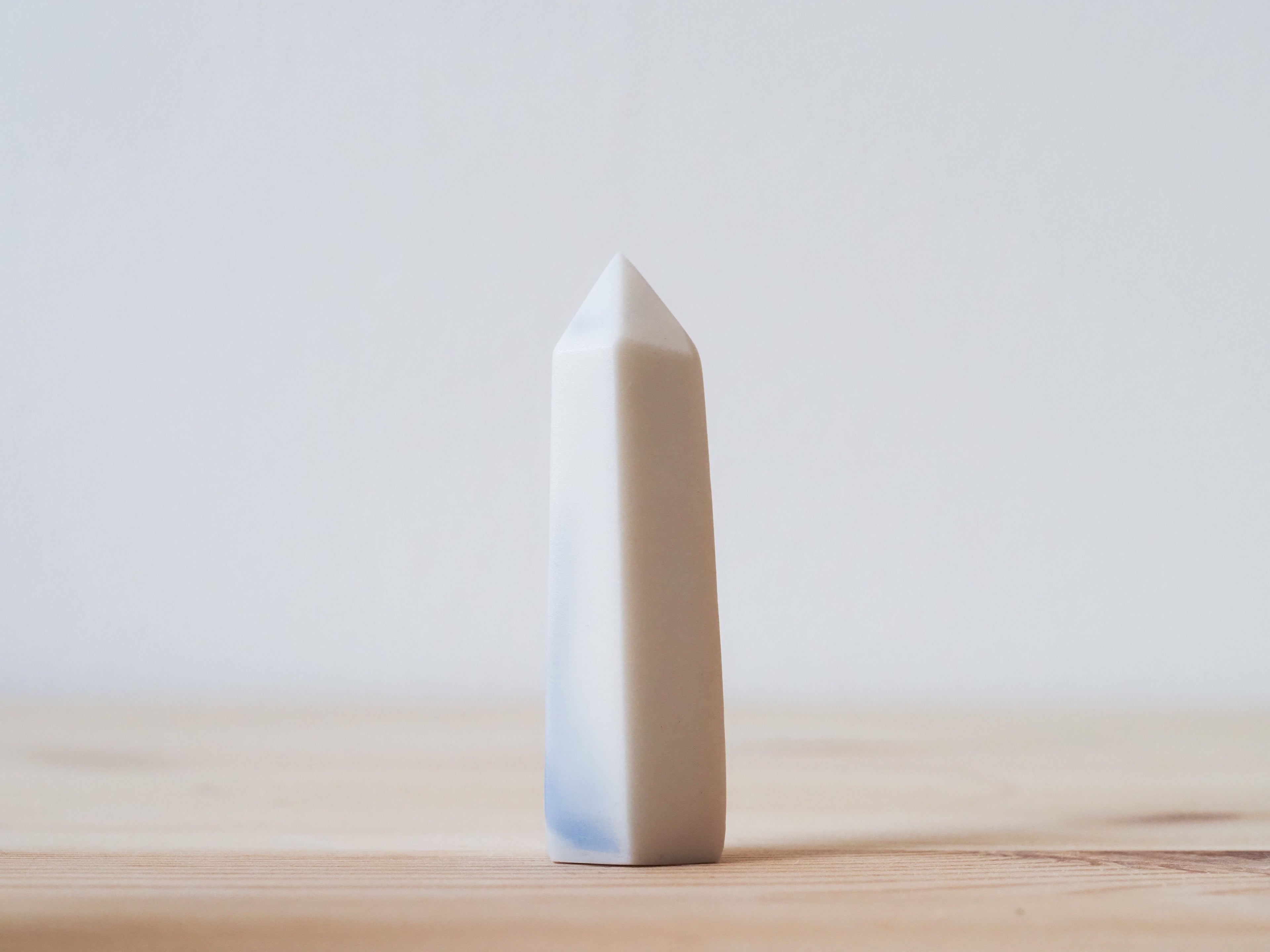 Handcrafted porcelain crystal sculpture, unique sculptural decorative piece with textured surface, subtle tints, and natural variations.
