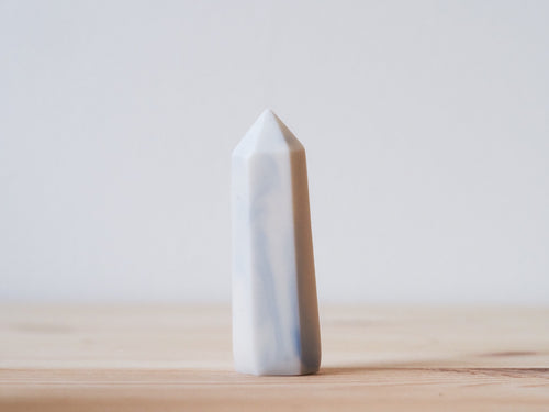 Handcrafted porcelain crystal sculpture, unique sculptural decorative piece with textured surface, subtle tints, and natural variations.